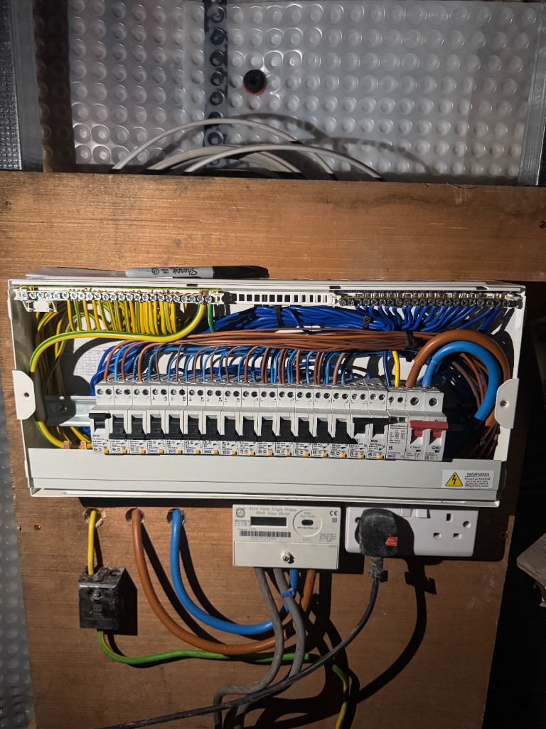 Open electrical consumer unit with professional wiring and circuit breakers