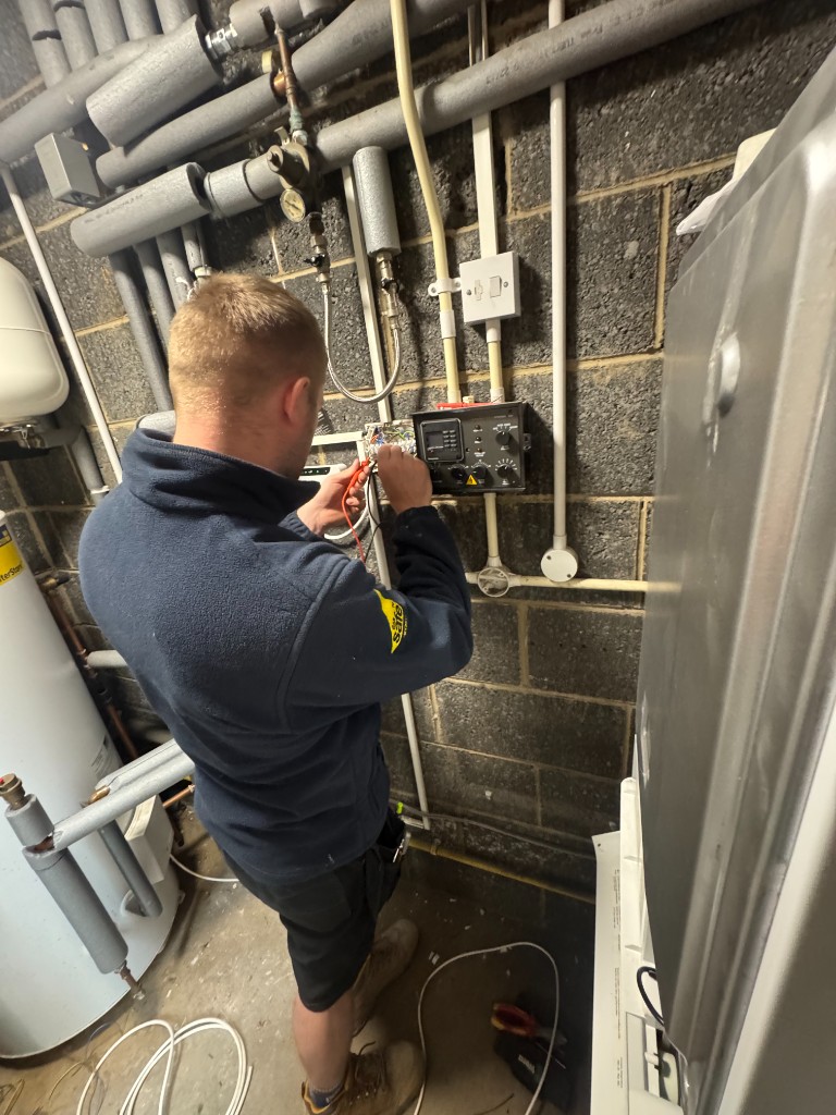 Qualified engineer testing heating and plumbing pipework on site